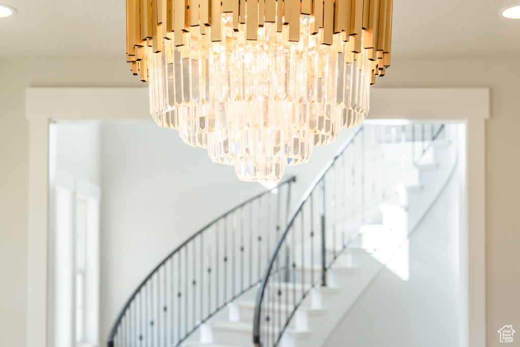 Staircase featuring an inviting chandelier
