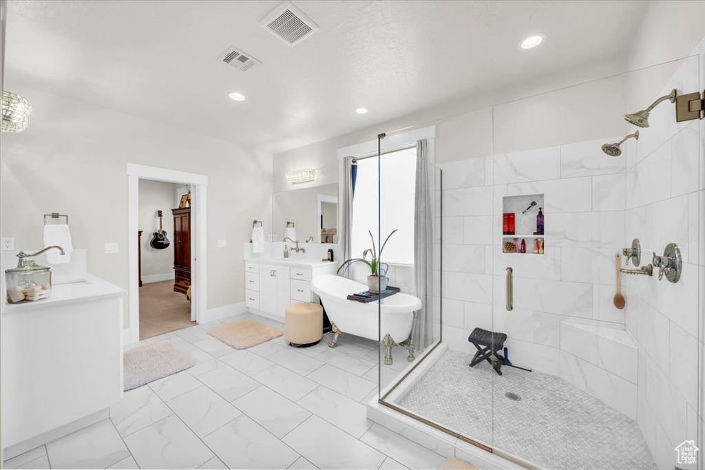 Bathroom with a shower with door, tile floors, and vanity