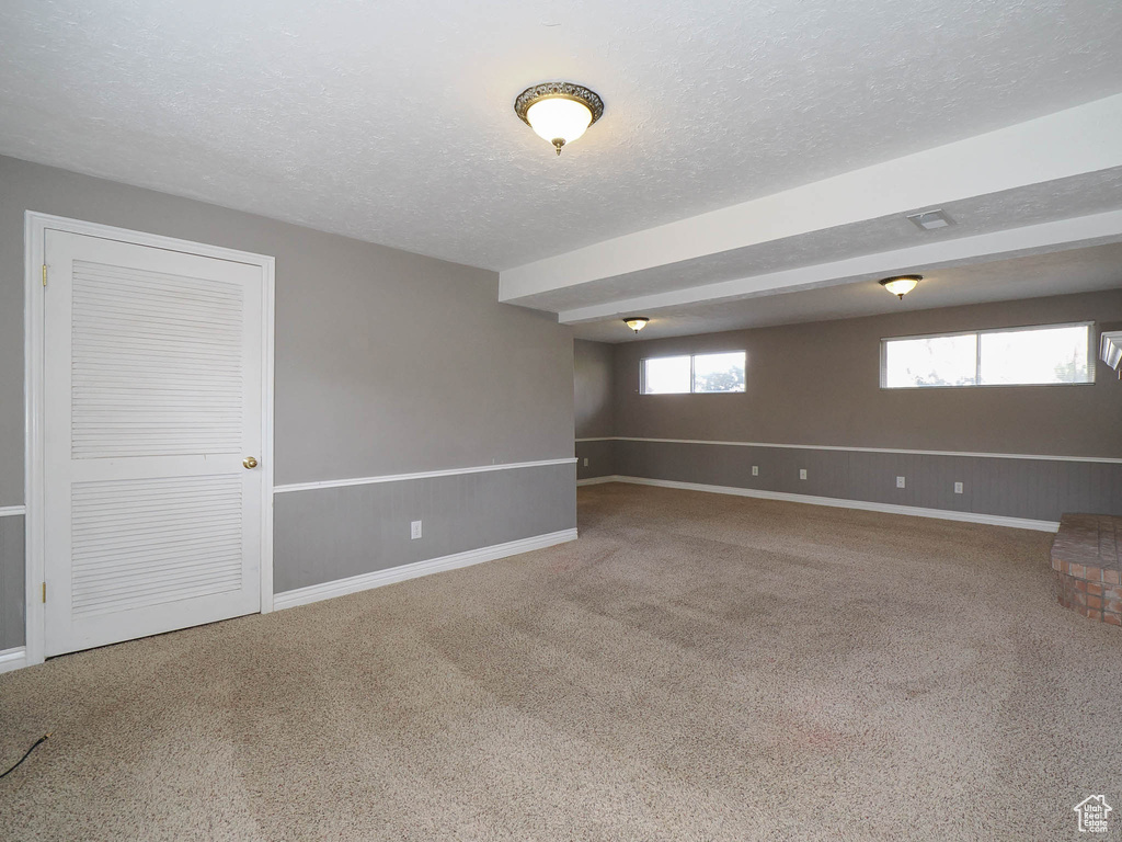 Spare room with carpet and a textured ceiling