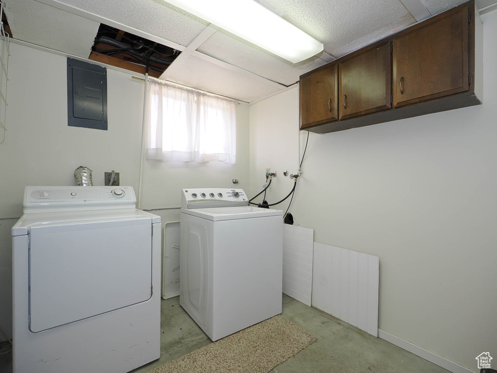Laundry area with cabinets, hookup for a washing machine, and washer and clothes dryer