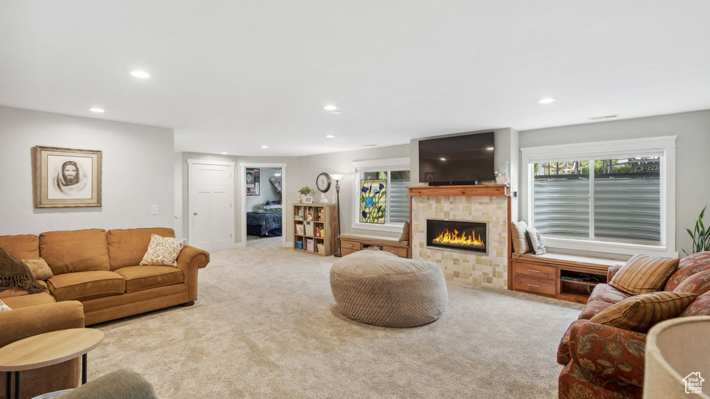 Carpeted living room featuring a wealth of natural light and a fireplace