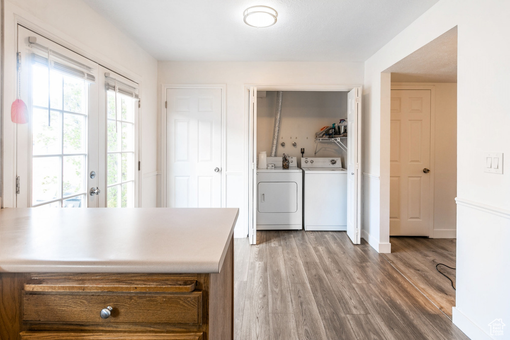 Kitchen featuring independent washer and dryer, french doors, and hardwood / wood-style floors