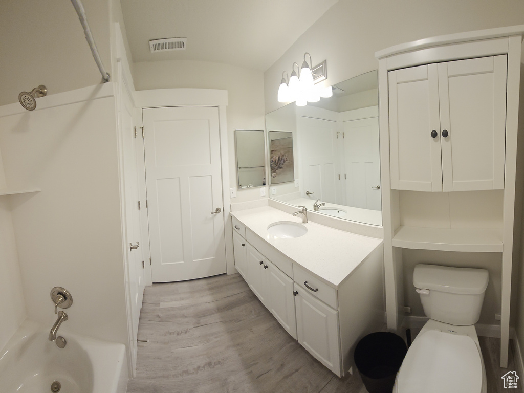 Full bathroom featuring bathtub / shower combination, oversized vanity, and toilet