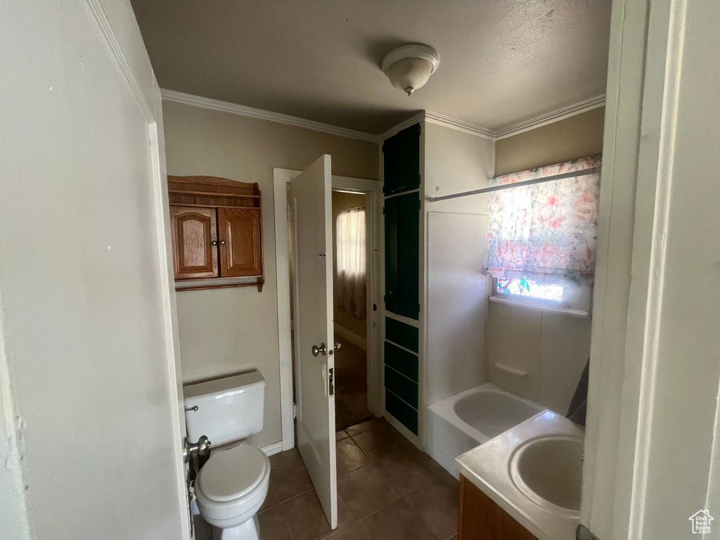 Full bathroom featuring tile flooring,  shower combination, vanity, and toilet
