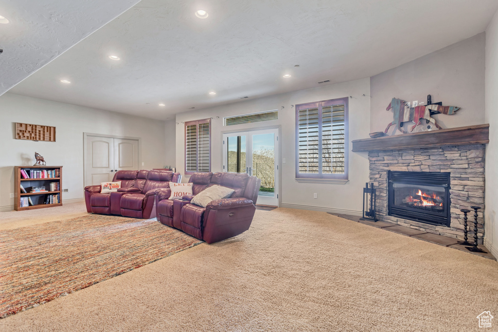 Carpeted living room with a fireplace
