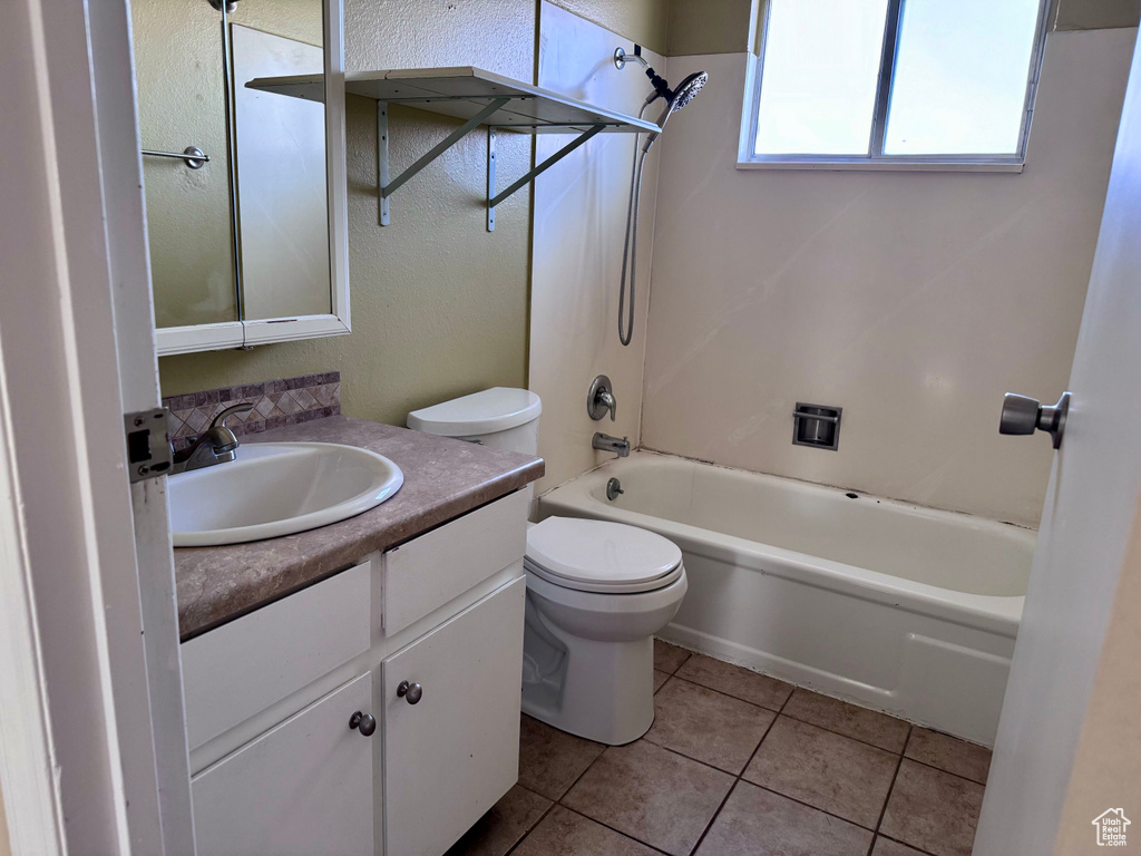 Full bathroom with tile floors, vanity,  shower combination, and toilet