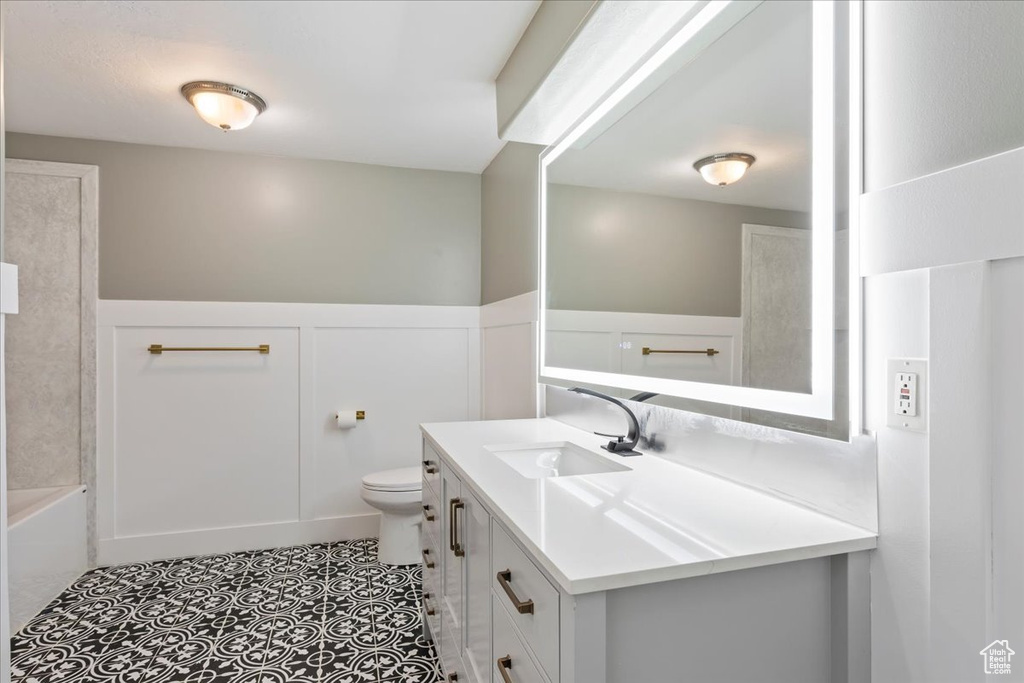 Full bathroom featuring shower / tub combination, vanity, toilet, and tile floors