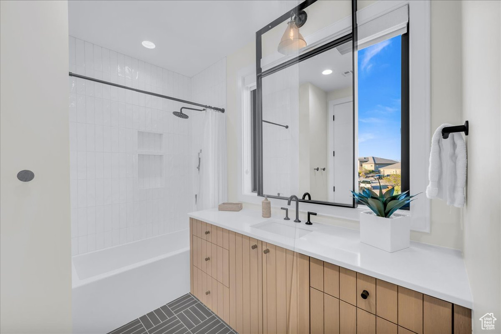 Bathroom with vanity and shower / tub combo