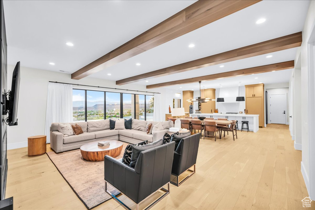 Living room featuring beam ceiling and light hardwood / wood-style floors