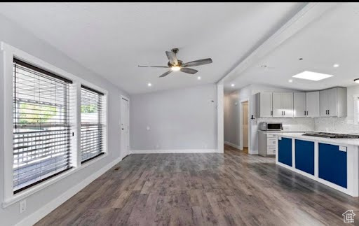 Kitchen featuring backsplash, ceiling fan, and hardwood / wood-style flooring