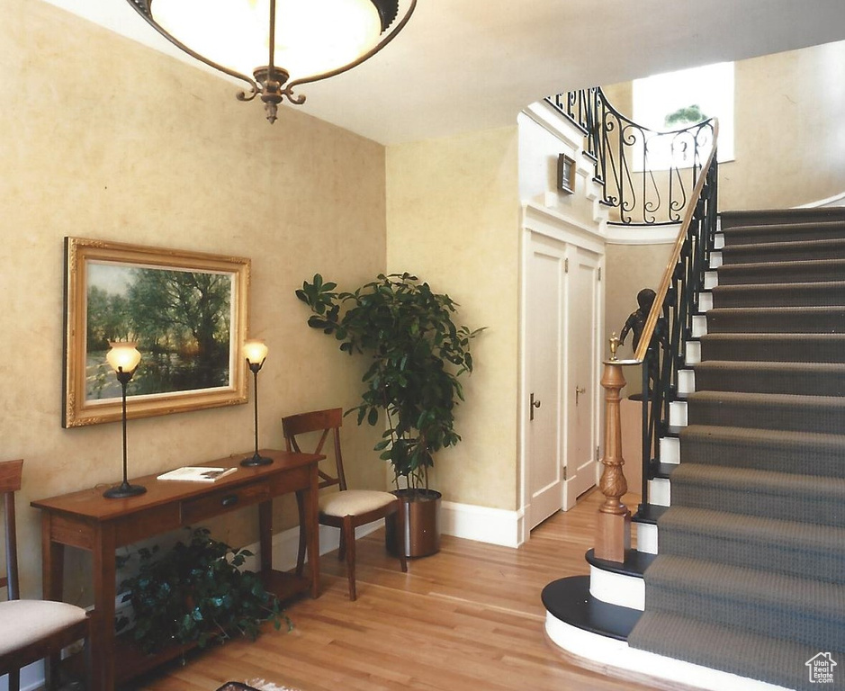 Stairway featuring light wood-type flooring