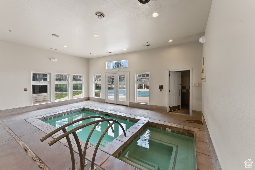 View of swimming pool with french doors