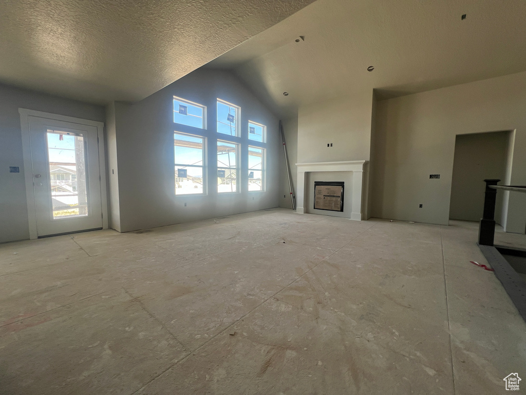 Unfurnished living room with a wealth of natural light and a textured ceiling