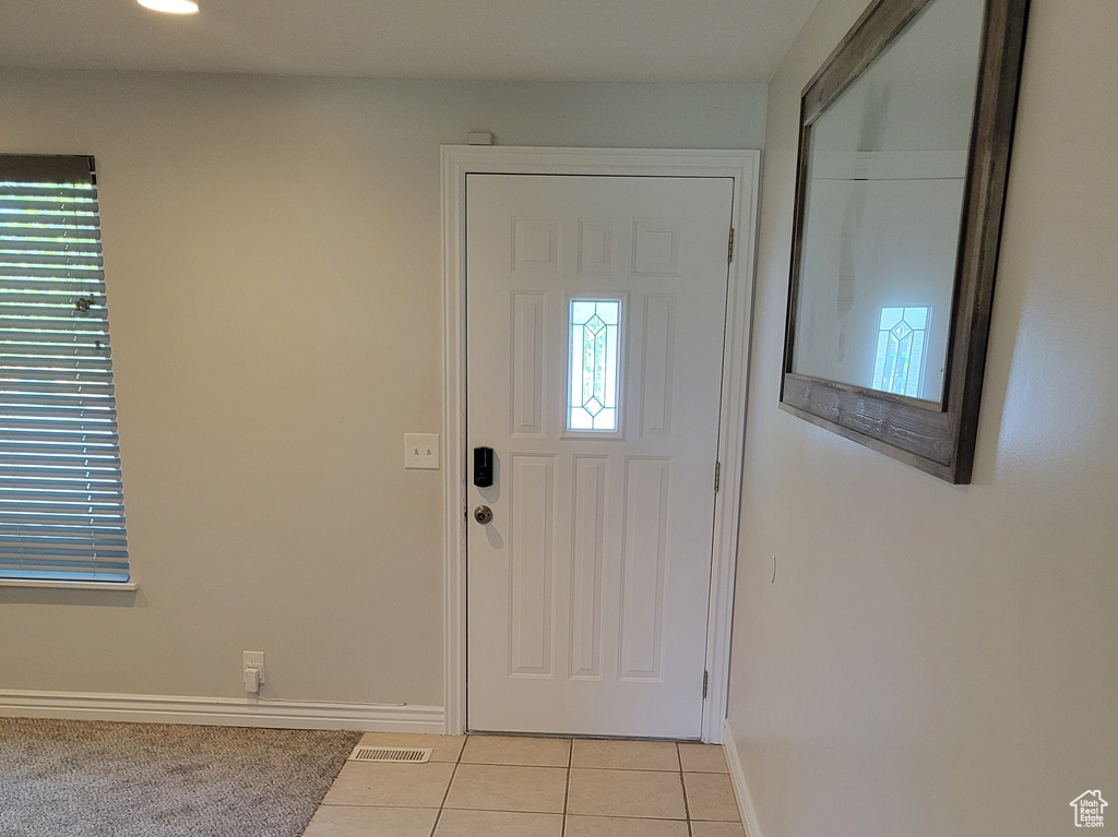 Entryway featuring light carpet