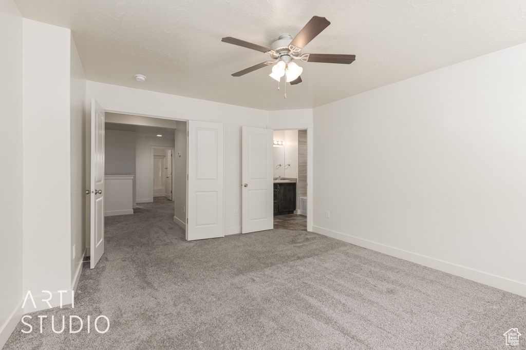 Unfurnished bedroom with ceiling fan and carpet floors
