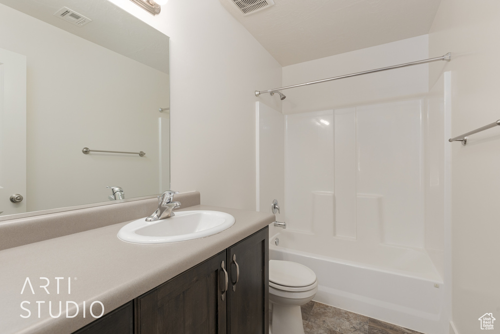 Full bathroom featuring shower / bathing tub combination, vanity, toilet, and tile flooring