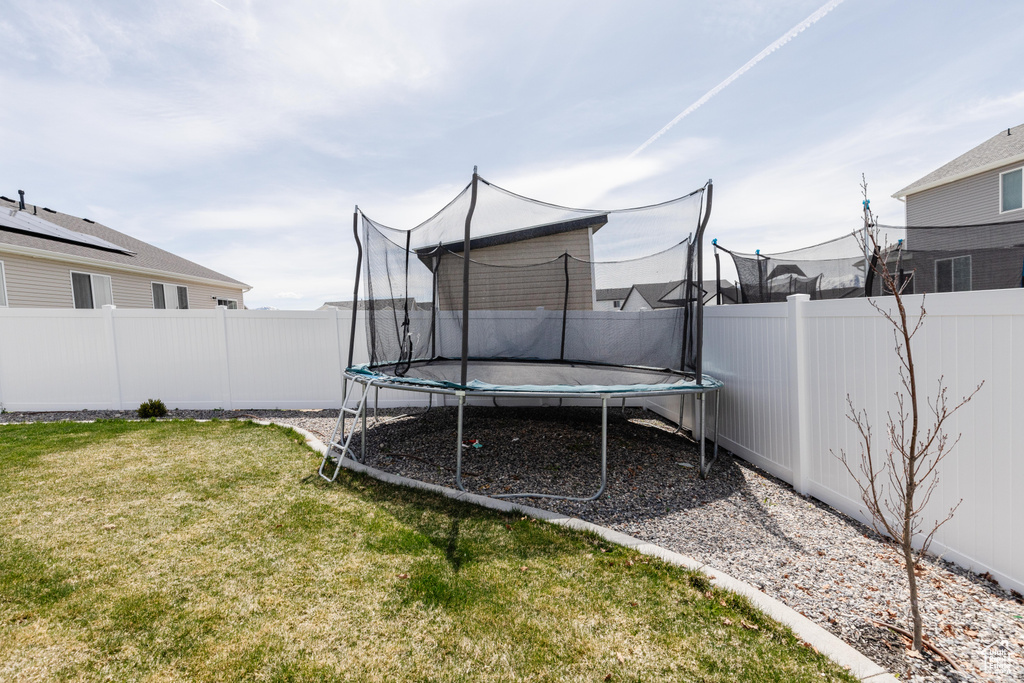 View of yard featuring a trampoline