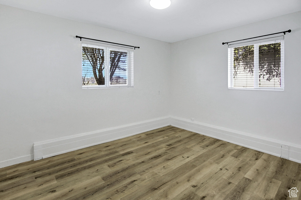 Spare room featuring wood-type flooring