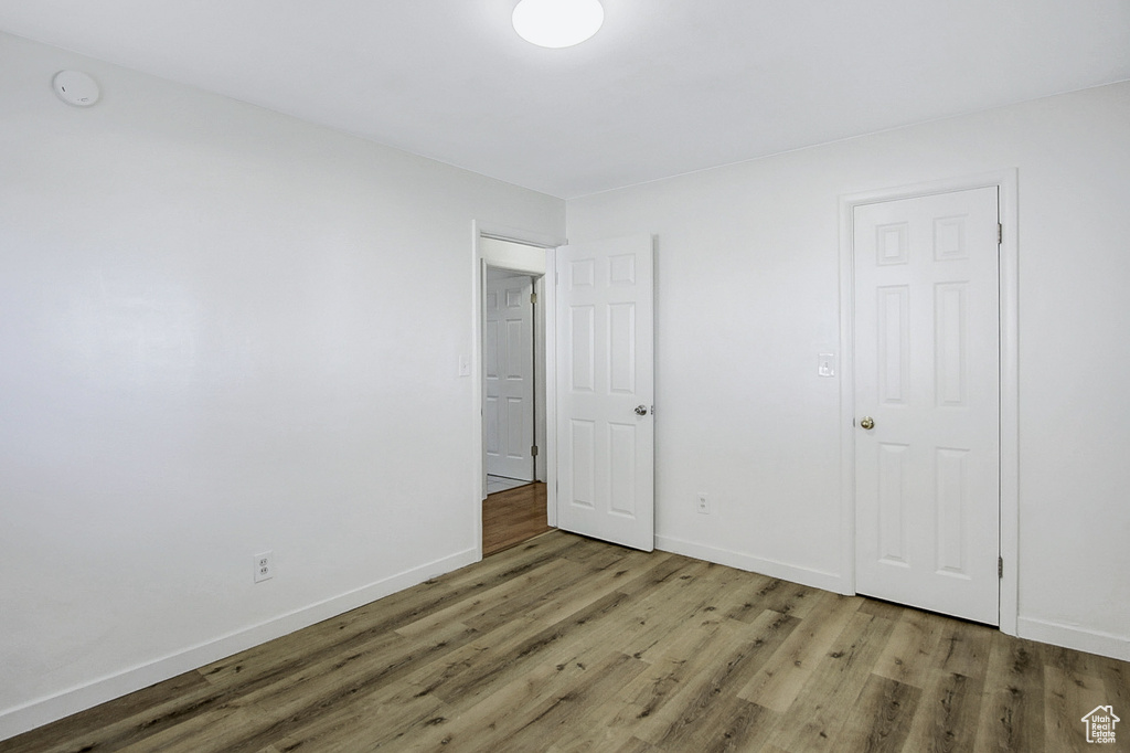 Unfurnished bedroom with wood-type flooring