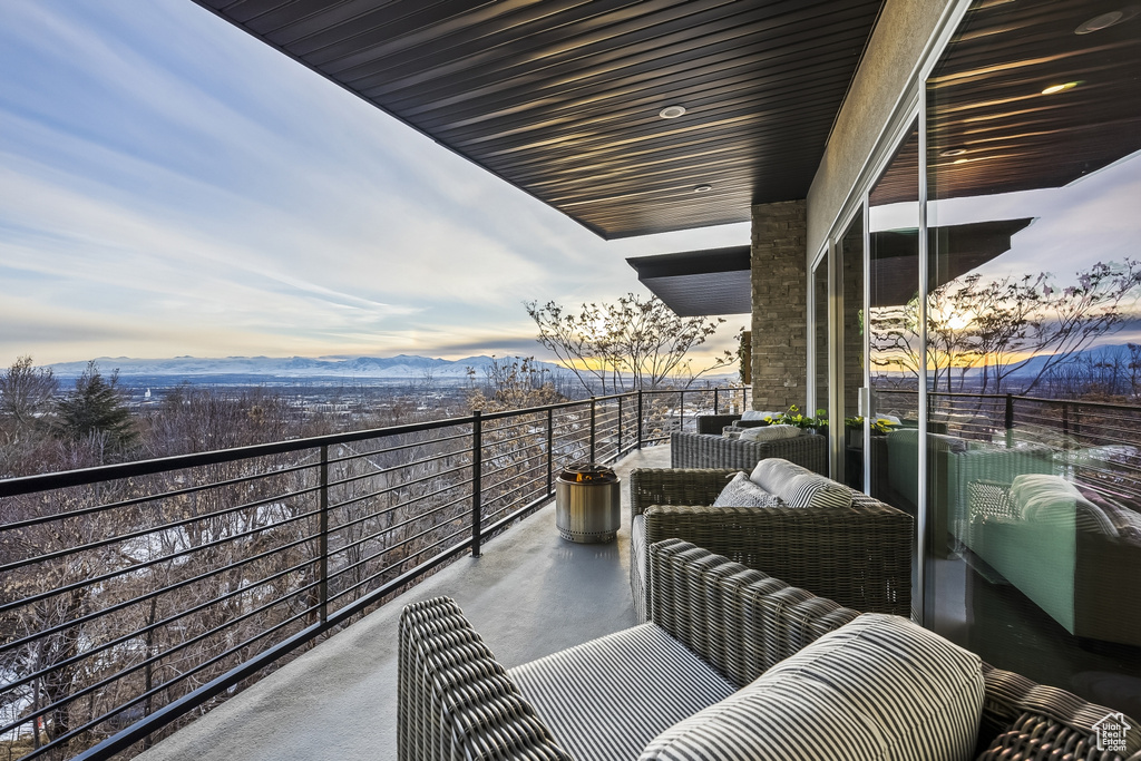 Balcony at dusk with an outdoor living space and a mountain view