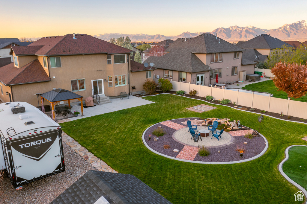 Exterior space with a patio area, a gazebo, and a mountain view