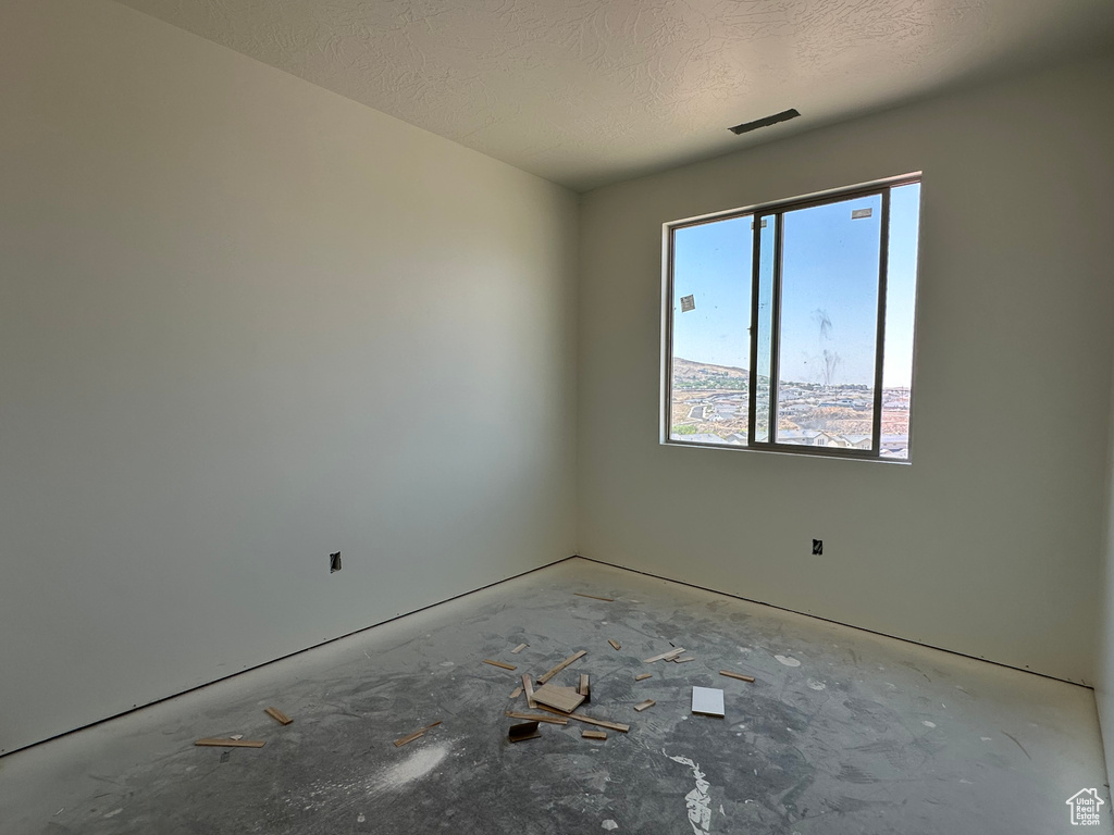 Empty room featuring a textured ceiling