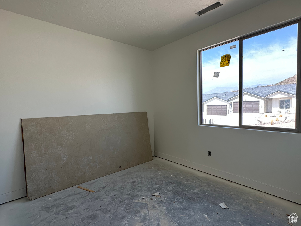 Unfurnished room featuring a textured ceiling