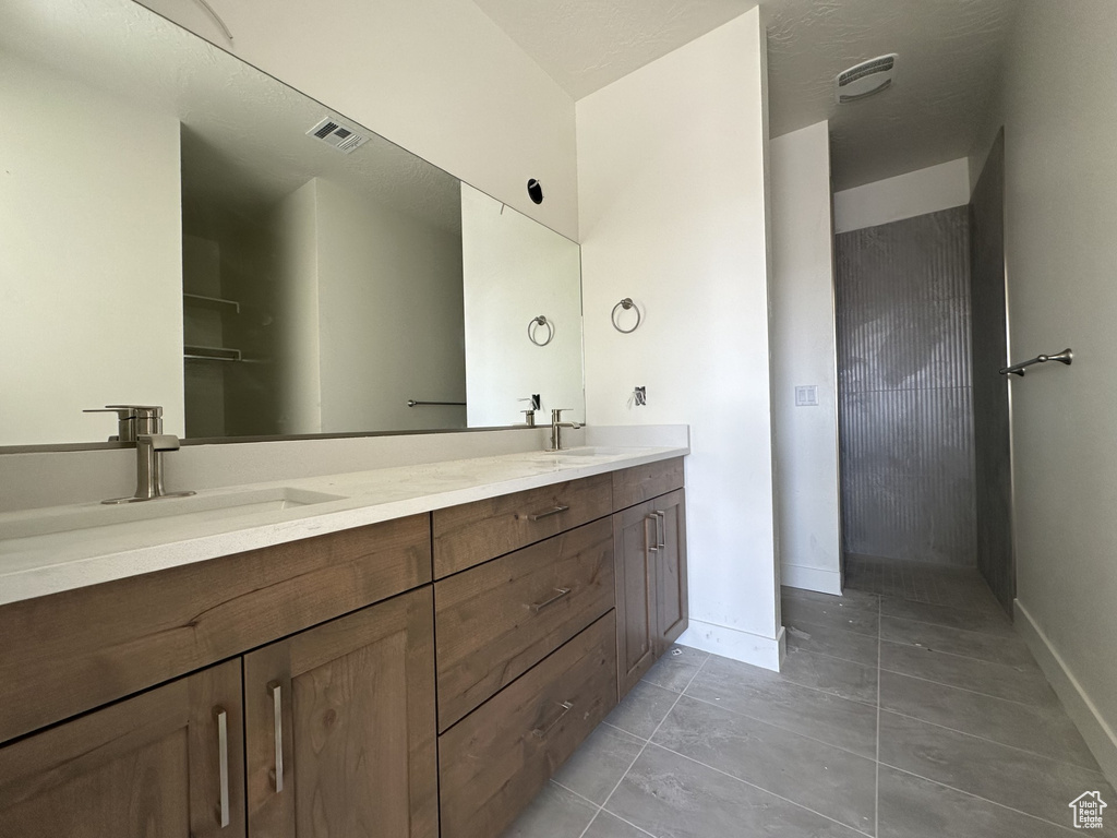 Bathroom featuring vanity and tile patterned floors