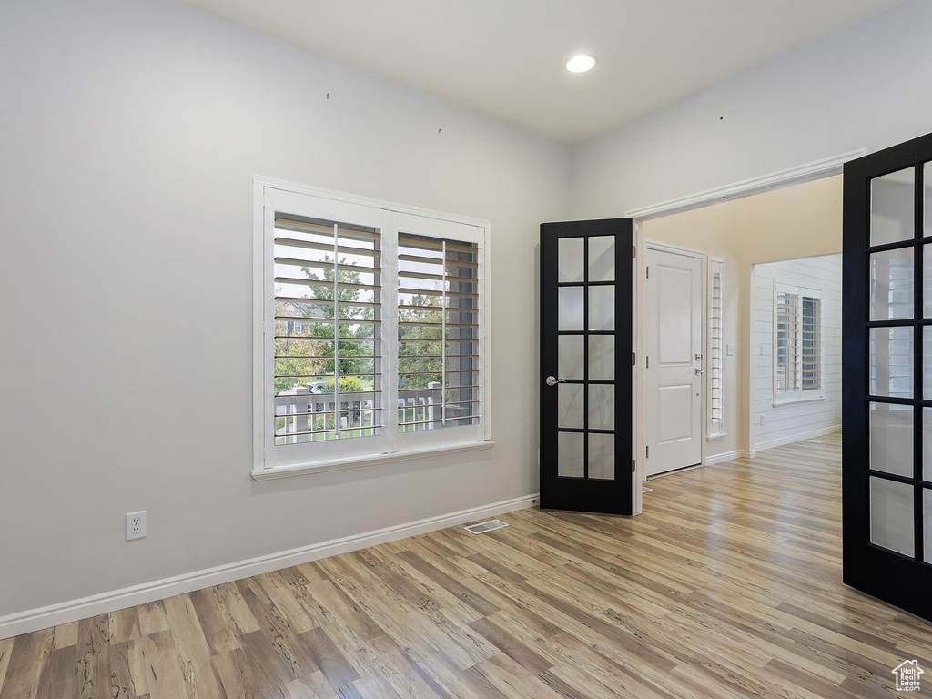 Spare room featuring light hardwood / wood-style flooring and french doors