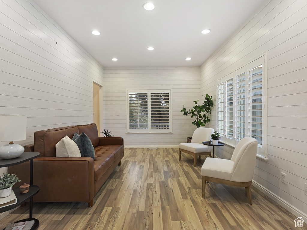 Living area featuring hardwood / wood-style flooring and wooden walls