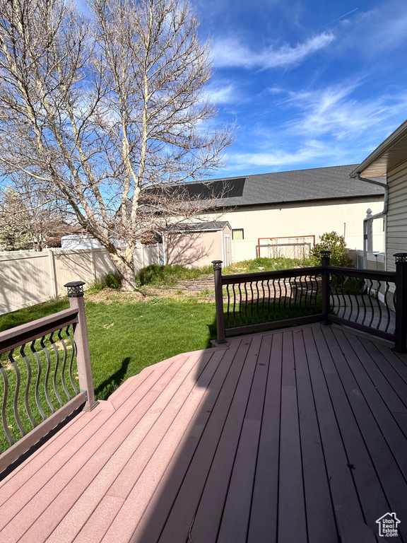 Wooden deck featuring a lawn