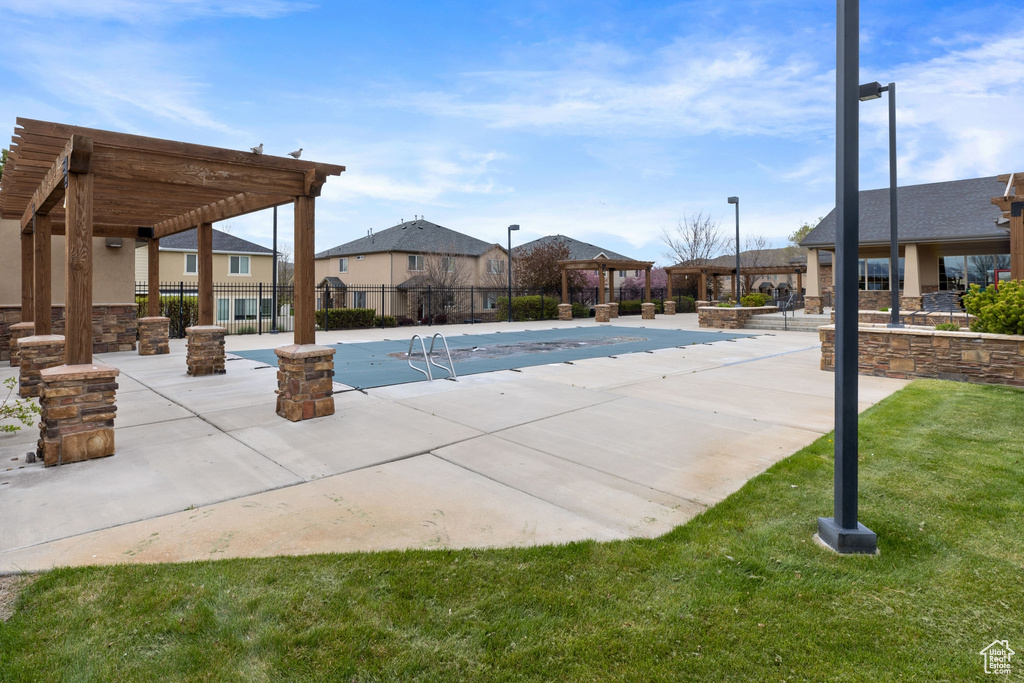 View of pool featuring a patio, a yard, and a pergola