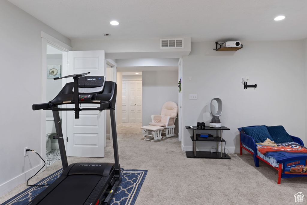 Workout area featuring light colored carpet
