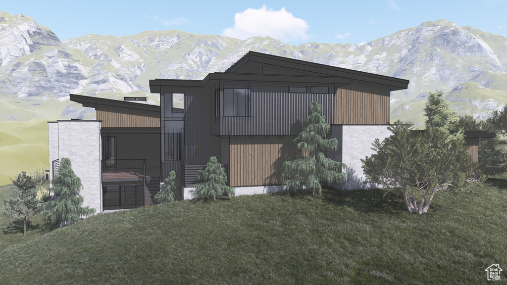 Modern home with a mountain view and a front lawn