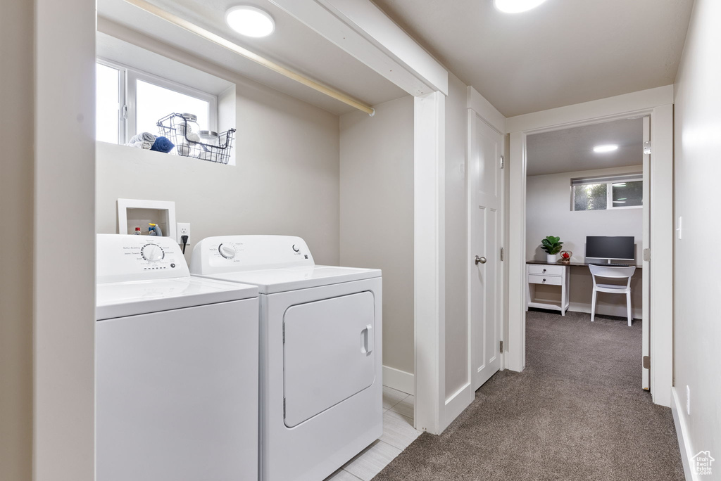 Laundry area featuring light carpet, hookup for a washing machine, and washer and clothes dryer
