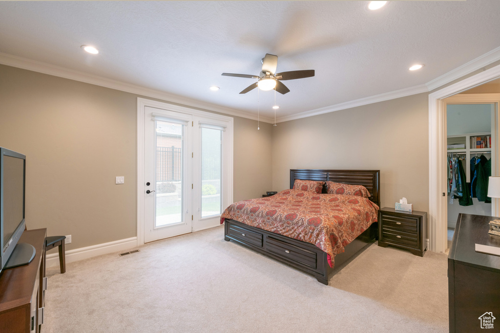 Carpeted bedroom with multiple windows, ceiling fan, access to outside, and ornamental molding
