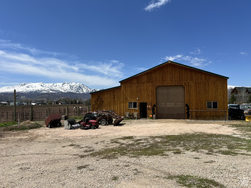 View of outdoor structure with a mountain view and a garage