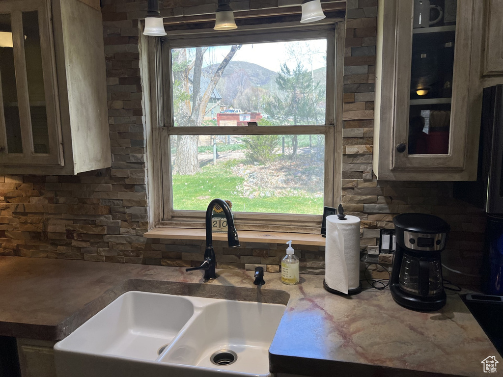 Kitchen featuring hanging light fixtures, sink, and a mountain view