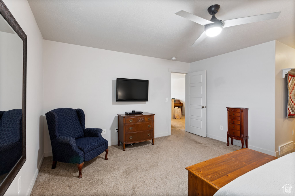 Interior space featuring ceiling fan and light carpet