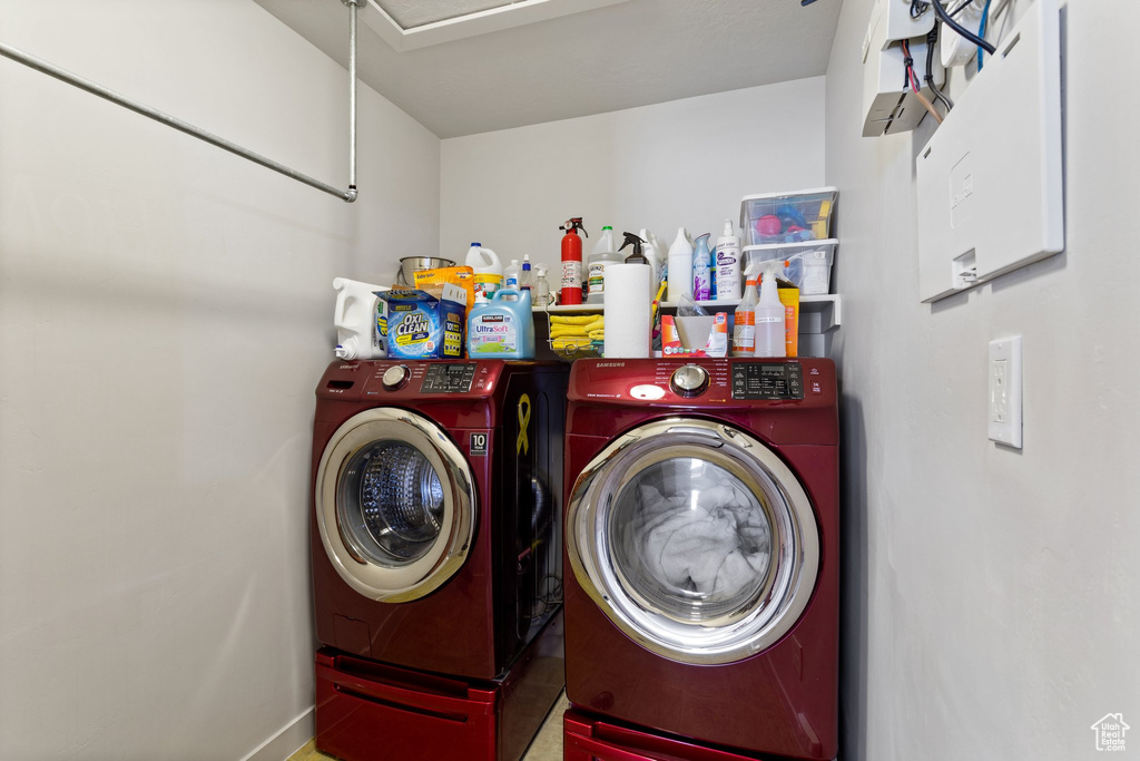 Clothes washing area with independent washer and dryer and tile flooring