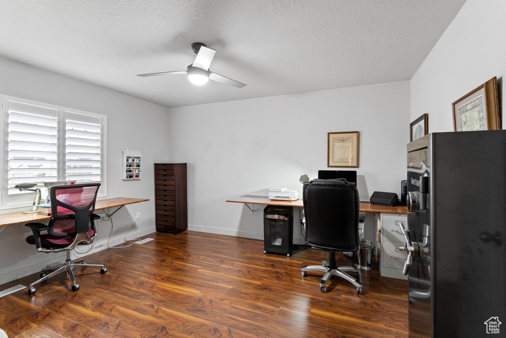 Office with ceiling fan, dark hardwood / wood-style floors, and a textured ceiling