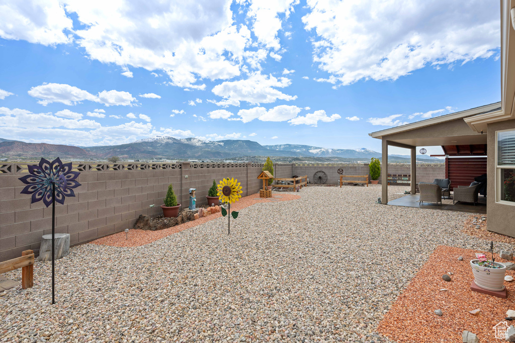 View of yard featuring a mountain view and a patio