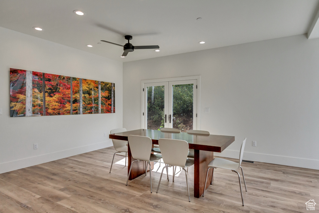 Dining space featuring french doors, ceiling fan, and light wood-type flooring
