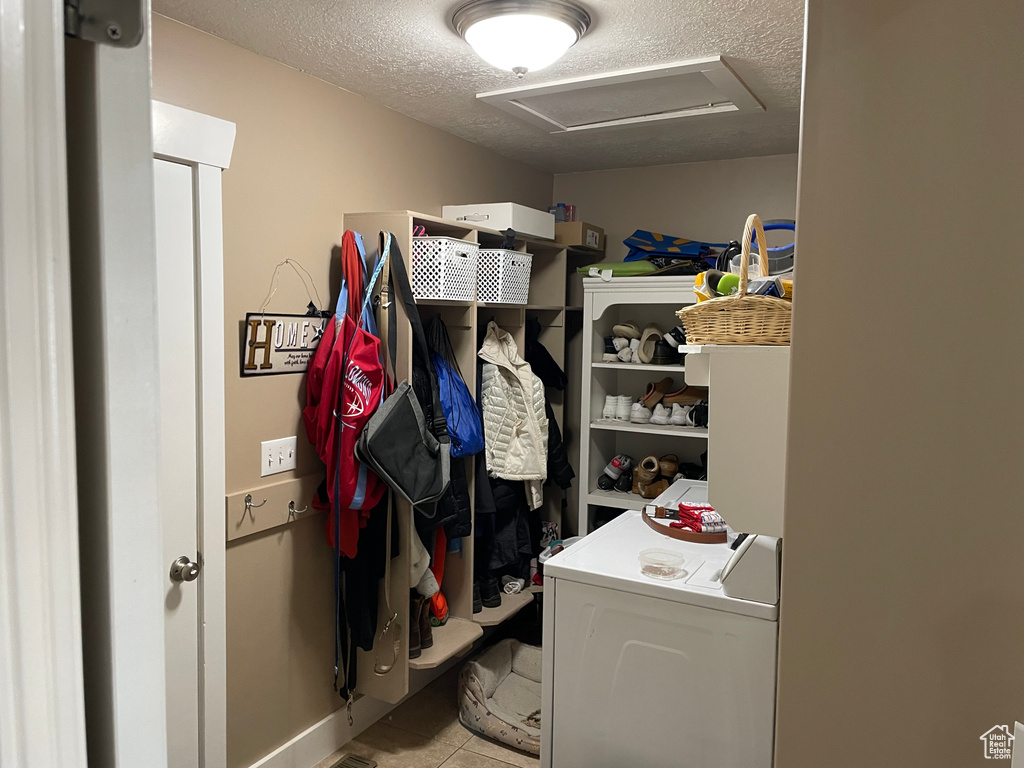 Spacious closet featuring separate washer and dryer and light tile flooring