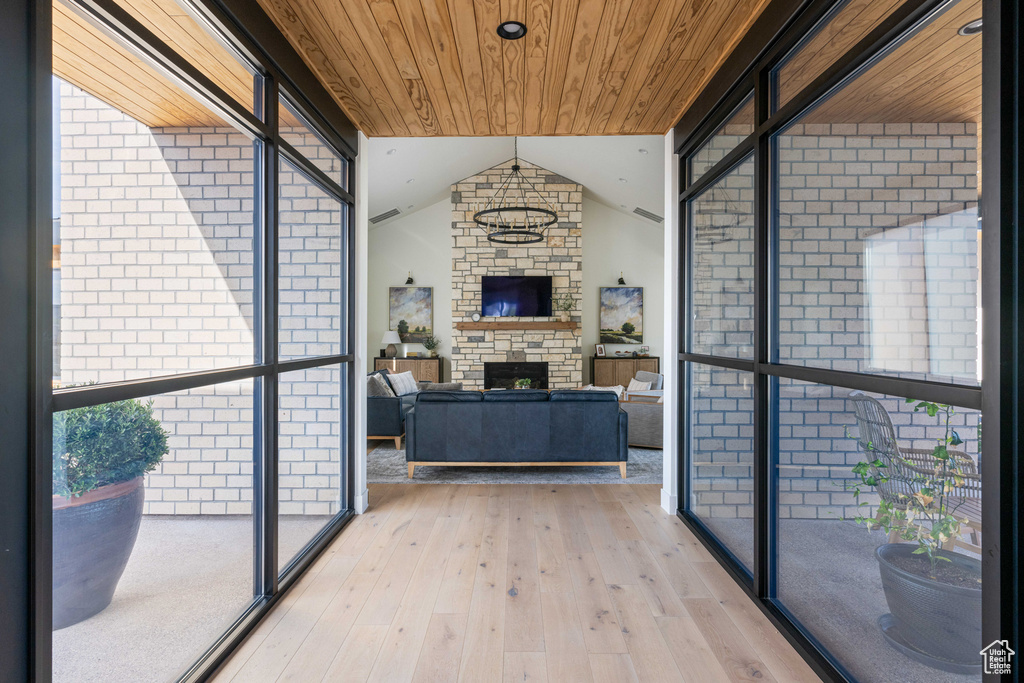 Interior space featuring lofted ceiling, a fireplace, and wood ceiling