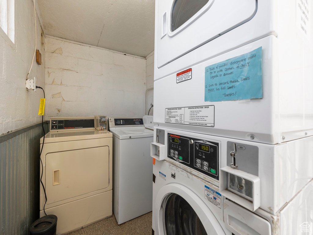 Clothes washing area with stacked washer and clothes dryer and independent washer and dryer