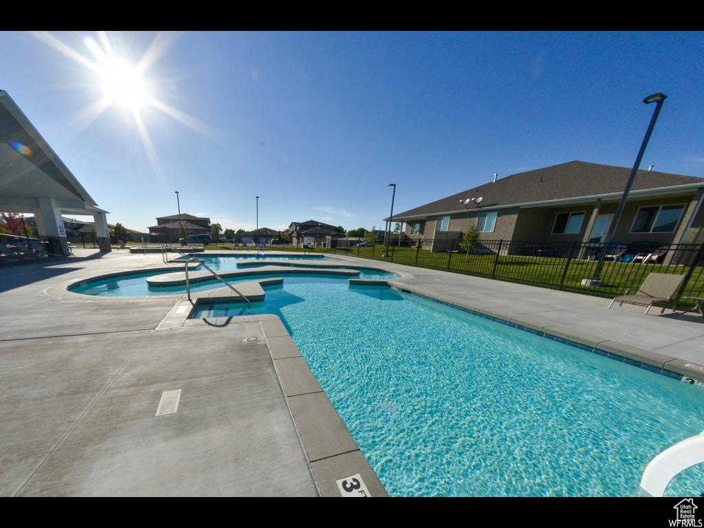 View of pool with a lawn