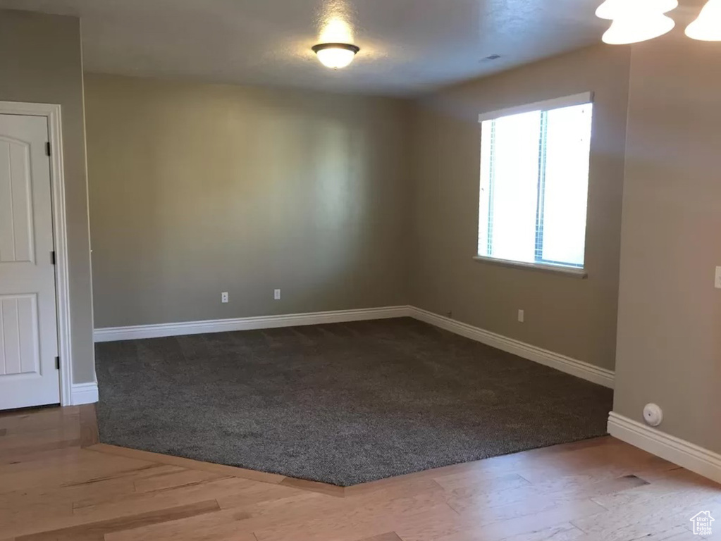 Empty room with hardwood / wood-style flooring