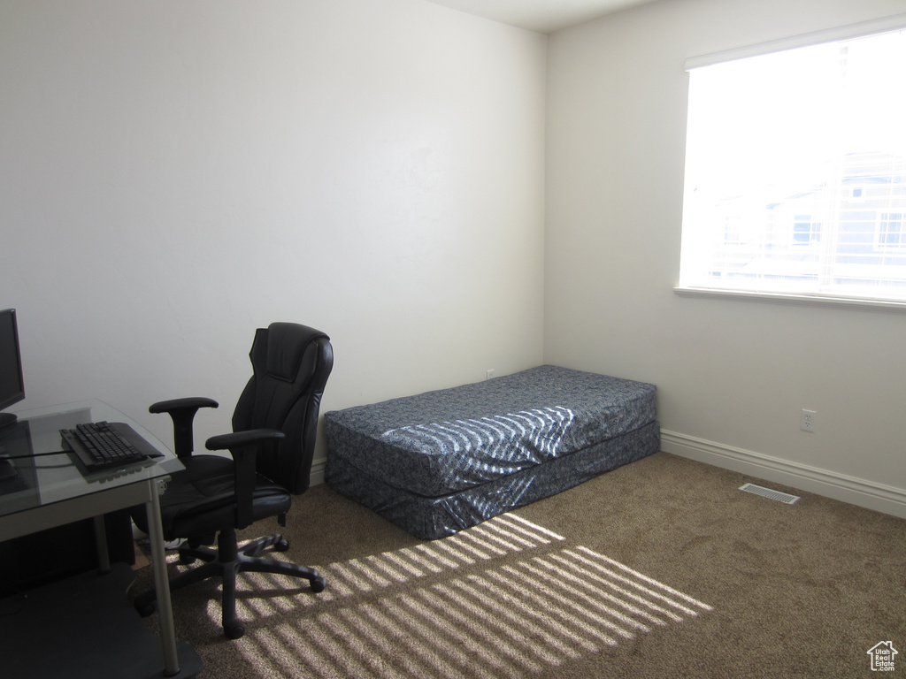 Bedroom featuring dark carpet