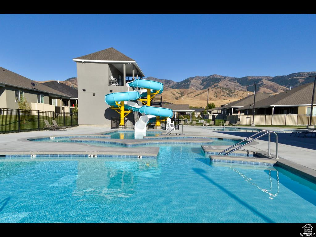 View of swimming pool featuring a mountain view and a water slide